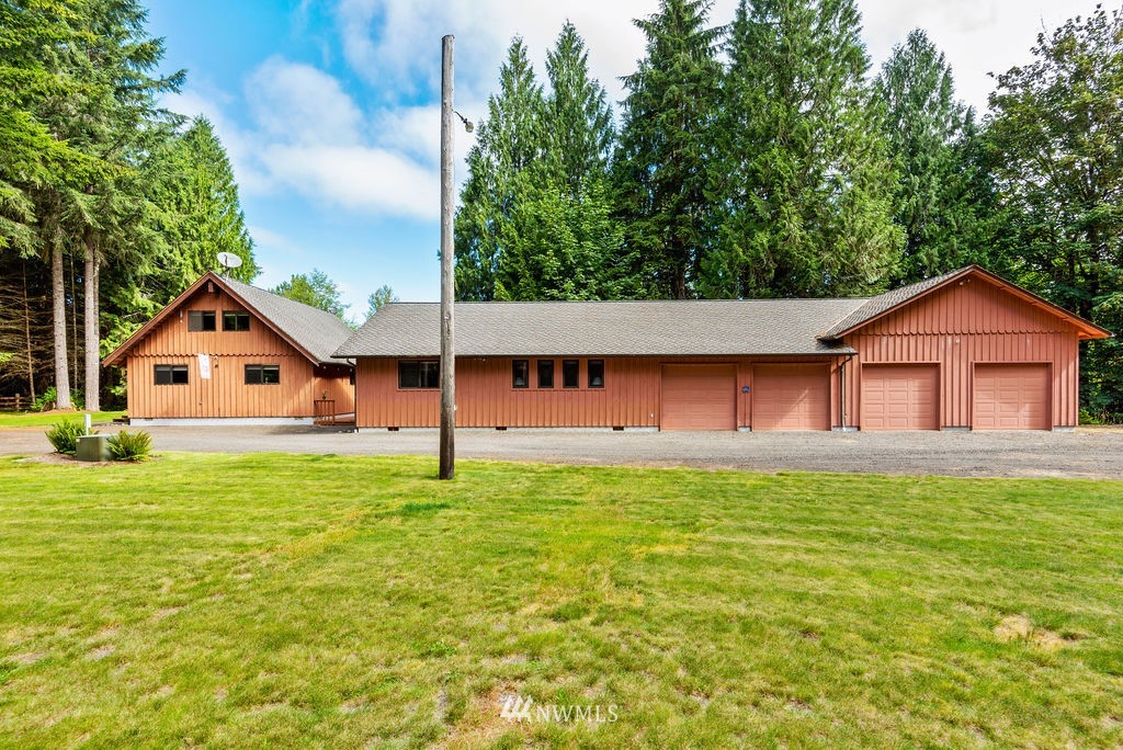 650 Frank Smith Road Toutle, WA 98649 - Photo 4 of 37 a front of a house with a yard and garage