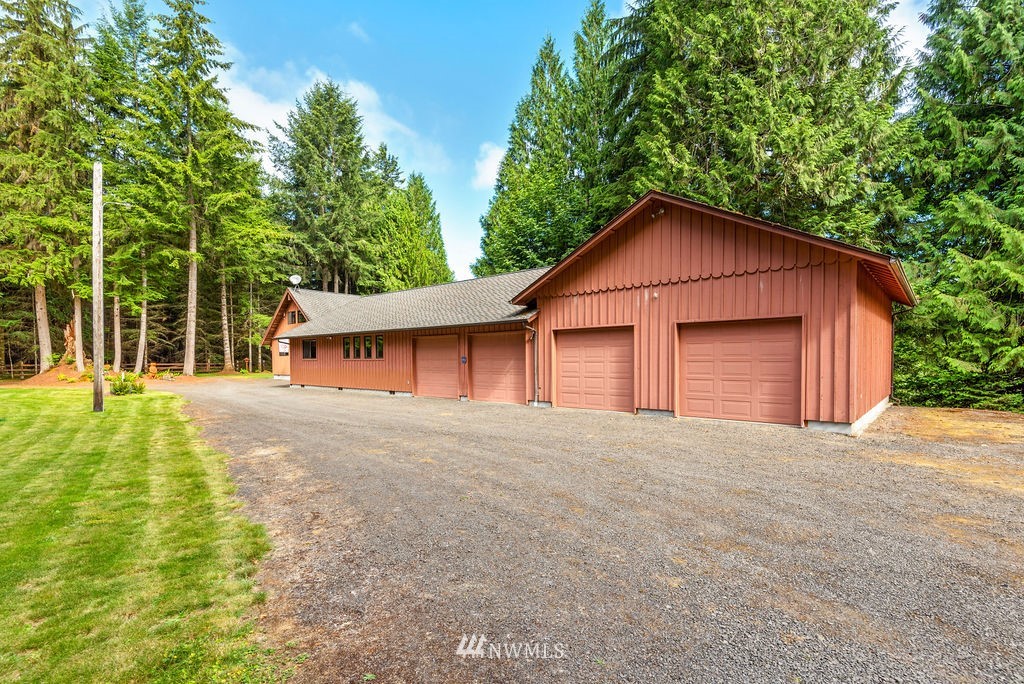 650 Frank Smith Road Toutle, WA 98649 - Photo 5 of 37 a front view of a house with a yard and garage