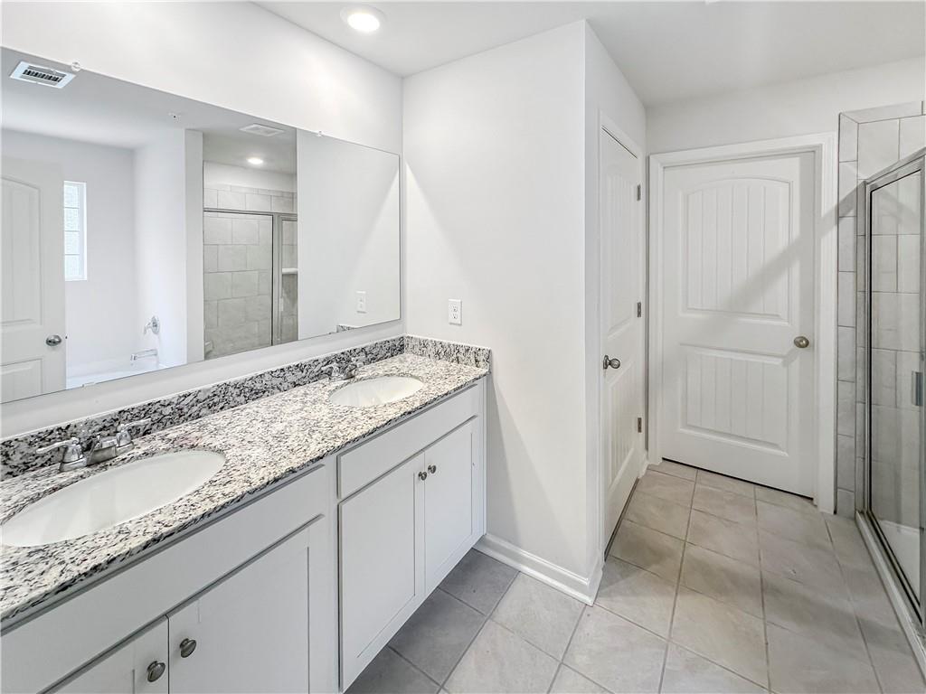 965 Athena Bend Fairburn, GA 30213 - Photo 15 of 37 a bathroom with a granite countertop sink and a mirror