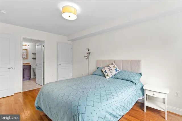 a bedroom with a bed and painting on the wall