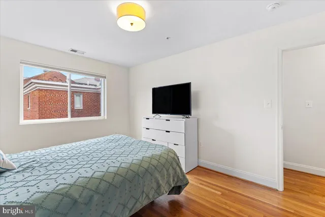 a bathroom with a granite countertop toilet sink and mirror