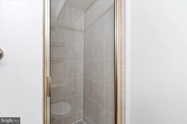 a bathroom with a granite countertop toilet sink and shower