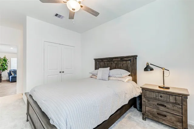 a bedroom with a bed and ceiling fan