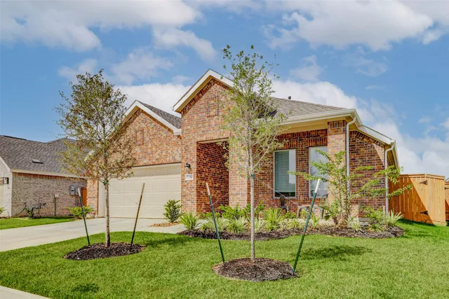 a view of a house with a yard and a garden