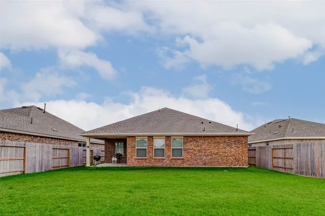 a view of a house with a yard and sitting area
