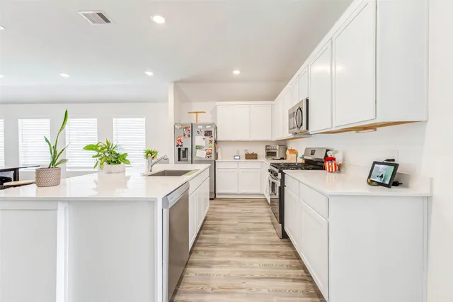 a kitchen with stainless steel appliances granite countertop a sink and cabinets