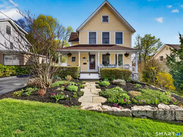 a front view of a house with a garden