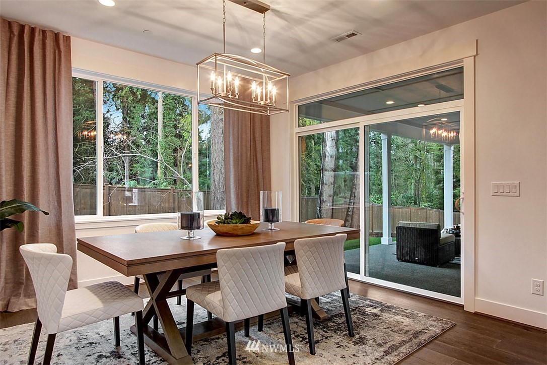 35 232nd Place Southeast Bothell, WA 98021 - Photo 8 of 24 a view of a dining room with furniture large windows wooden floor and garden view