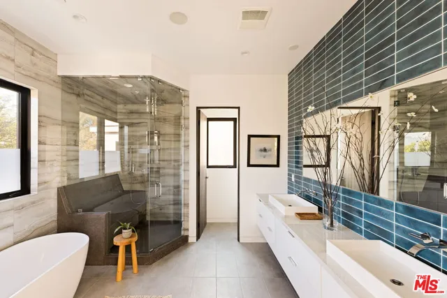 a front view of a house with wooden floor and seating area