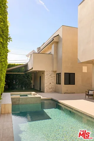 a bathroom with a sink a mirror and a shower