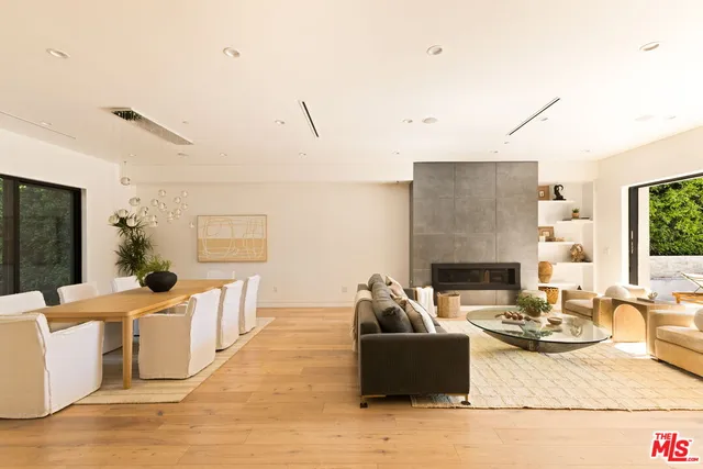 a living room with furniture floor to ceiling window and floor