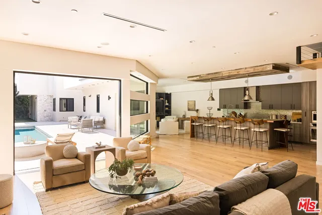 a kitchen with stainless steel appliances a stove a sink and a refrigerator