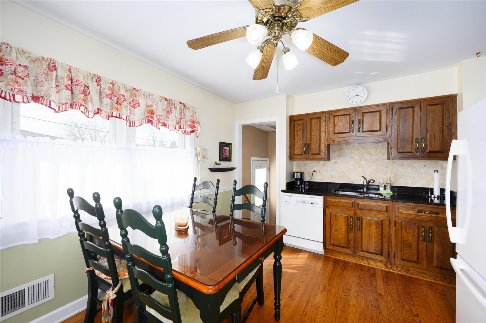 1512 Herbert Avenue Berkeley, IL 60163 - Photo 11 of 33 a kitchen with stainless steel appliances granite countertop a dining table chairs and a refrigerator