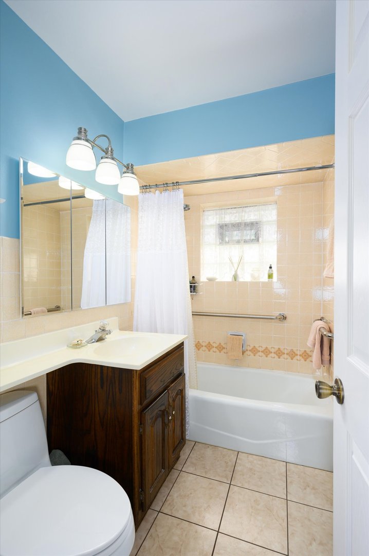 1512 Herbert Avenue Berkeley, IL 60163 - Photo 15 of 33 a bathroom with a sink a toilet and a mirror