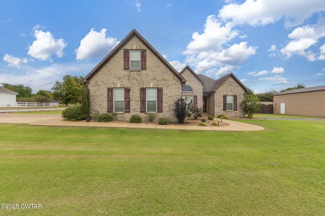 a front view of a house with swimming pool having outdoor seating