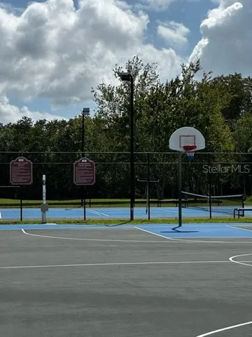 a view of a tennis ground with houses
