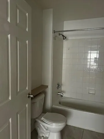 a bathroom with a toilet and shower