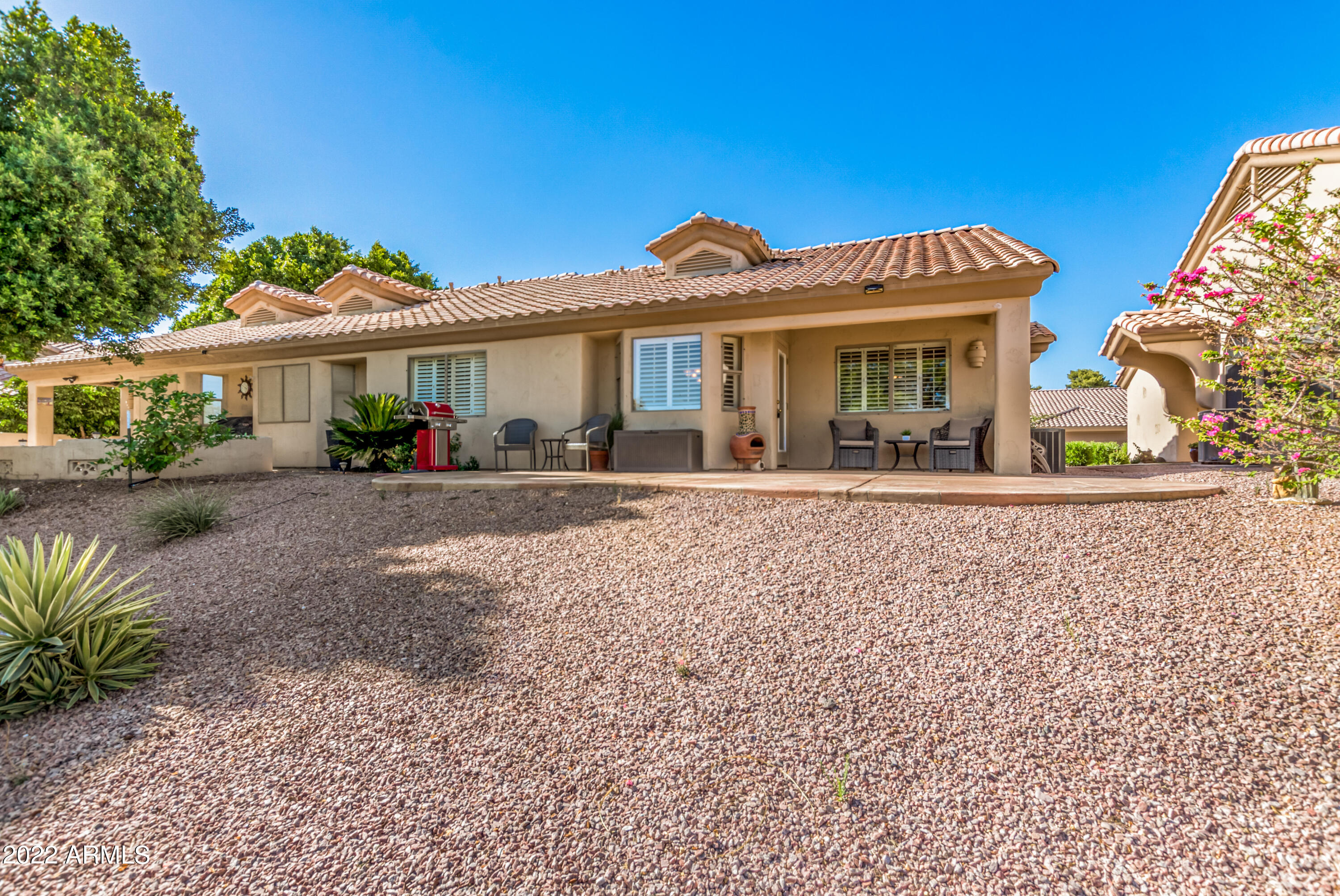 5830 East McKellips Road, Unit 76 Mesa, AZ 85215 - Photo 28 of 33 a front view of a house with a yard