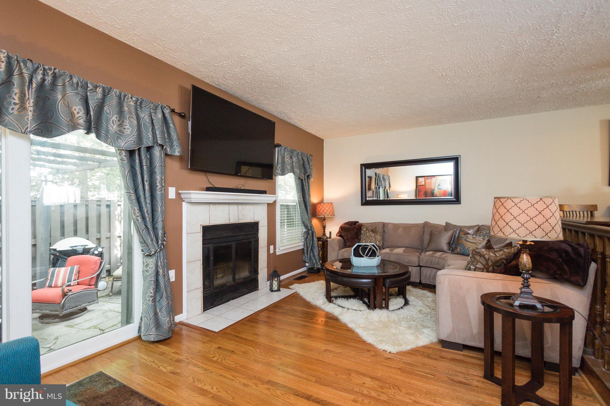 7381 Stream Way Springfield, VA 22152 - Photo 5 of 26 Living room leads to flagstone patio.