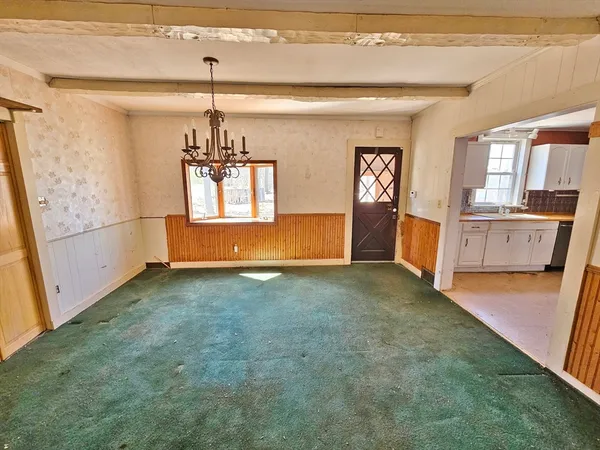 a view of a livingroom with a fireplace a ceiling fan and wooden floor