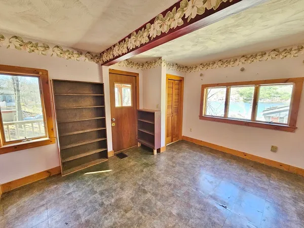 en empty room with window and a ceiling fan