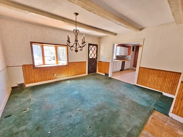 a view of a room with window and kitchen view