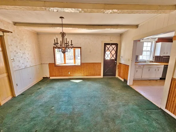 a view of a livingroom with a fireplace a ceiling fan and wooden floor