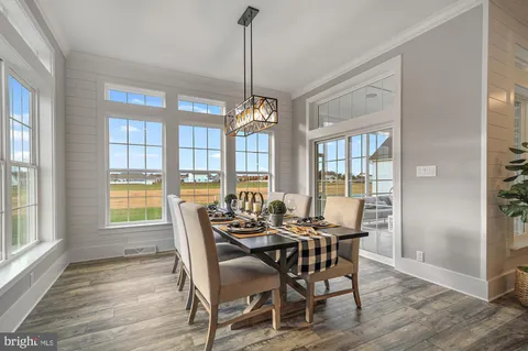 a dining room with furniture window wooden floor