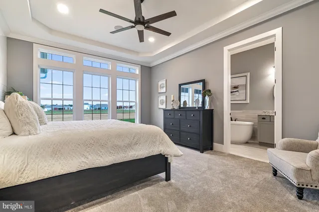 a bedroom with a large bed and a chandelier