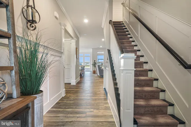 a view of entryway and hall with wooden floor