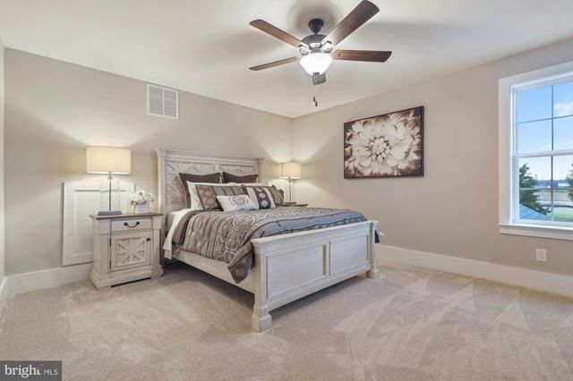 a spacious bedroom with a bed and a window