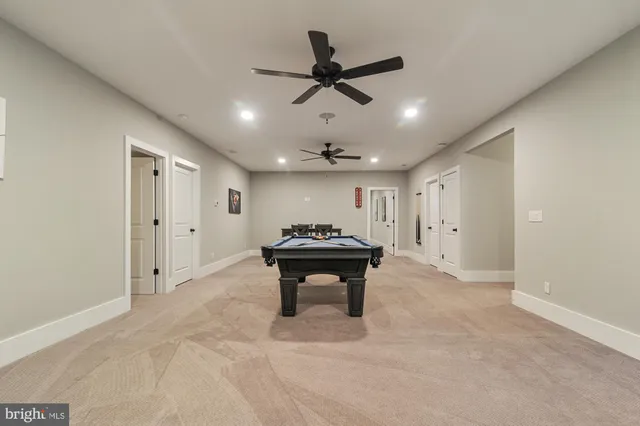 a living room with furniture and a ceiling fan