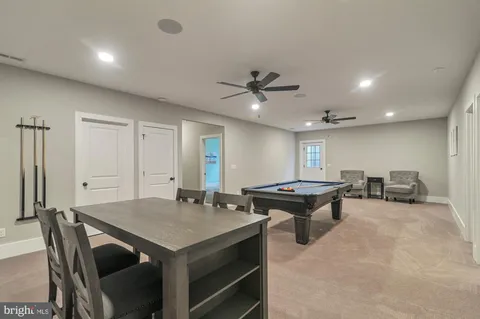 a open kitchen with stainless steel appliances granite countertop a stove a sink dishwasher and a refrigerator with wooden floor