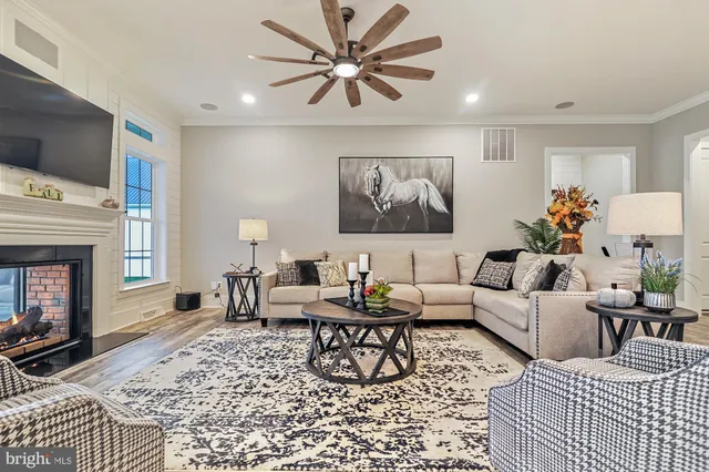 a living room with furniture and a fireplace