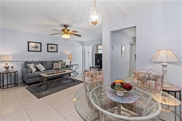 161 Northeast 10th Avenue, Unit 7C Hallandale Beach, FL 33009 - Photo 12 of 27 a living room with furniture and a lamp