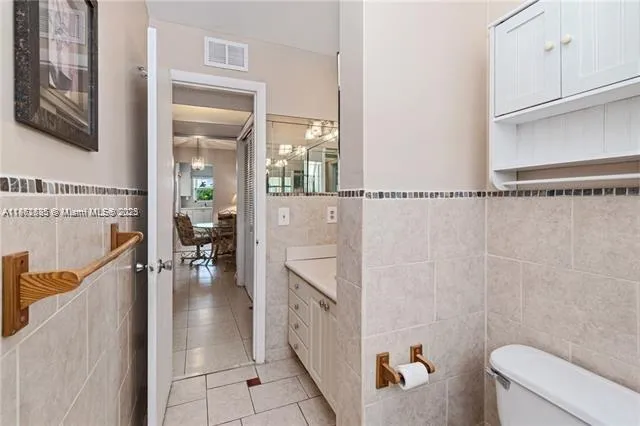 a bathroom with a shower a sink and a toilet