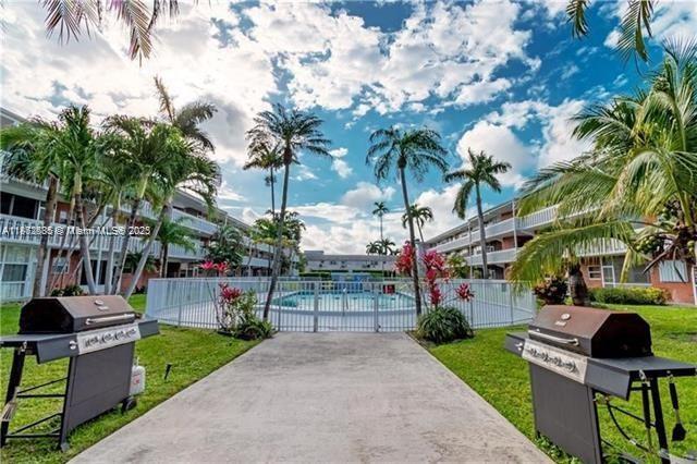 161 Northeast 10th Avenue, Unit 7C Hallandale Beach, FL 33009 - Photo 23 of 27 a view of a park with plants and a bench