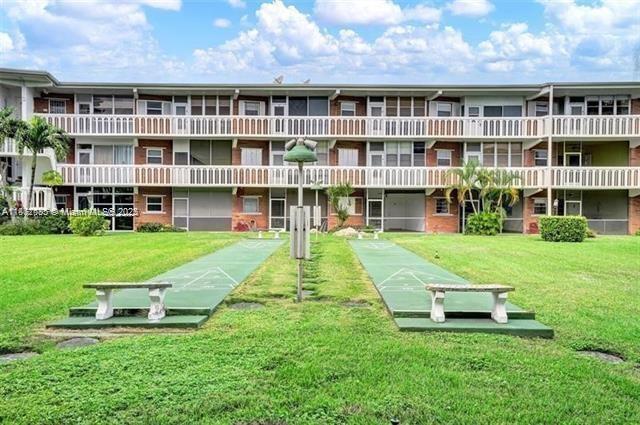 161 Northeast 10th Avenue, Unit 7C Hallandale Beach, FL 33009 - Photo 27 of 27 a view of a house with a yard and sitting area