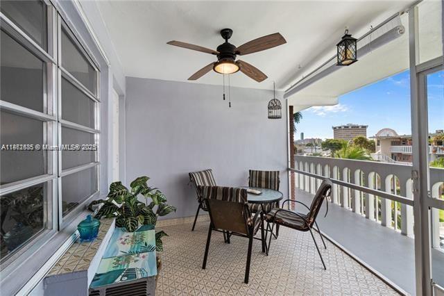161 Northeast 10th Avenue, Unit 7C Hallandale Beach, FL 33009 - Photo 4 of 27 a workspace with furniture window and wooden floor