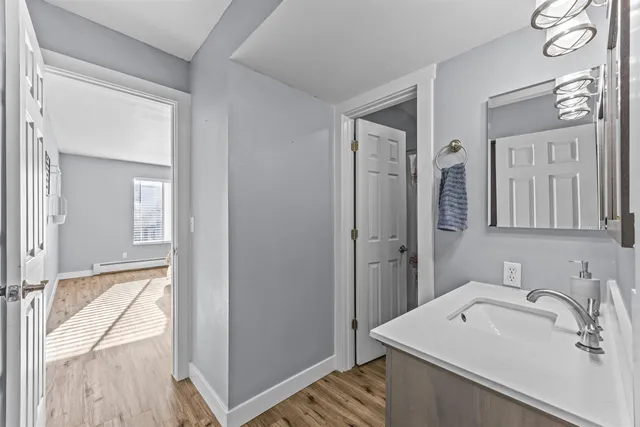 a bathroom with a sink a mirror and a shower