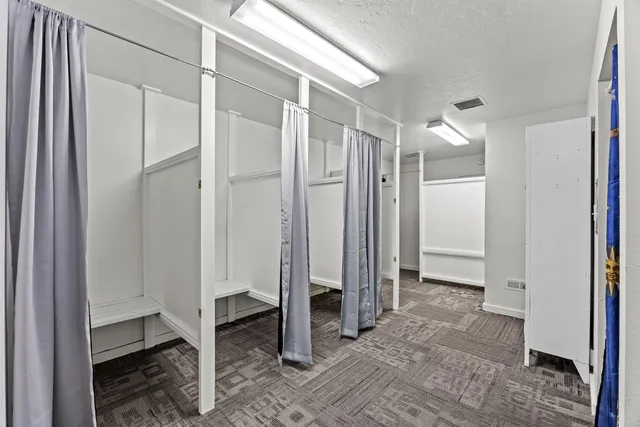 a view of a bathroom with a walk in closet and bedroom