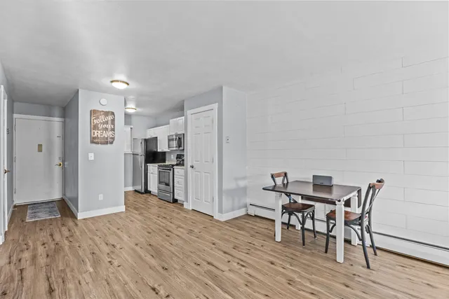 a view of a dining room with furniture and wooden floor