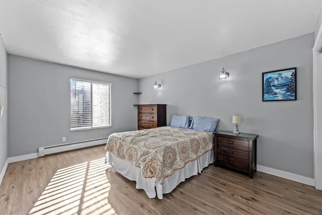 a bedroom with a bed and a large window