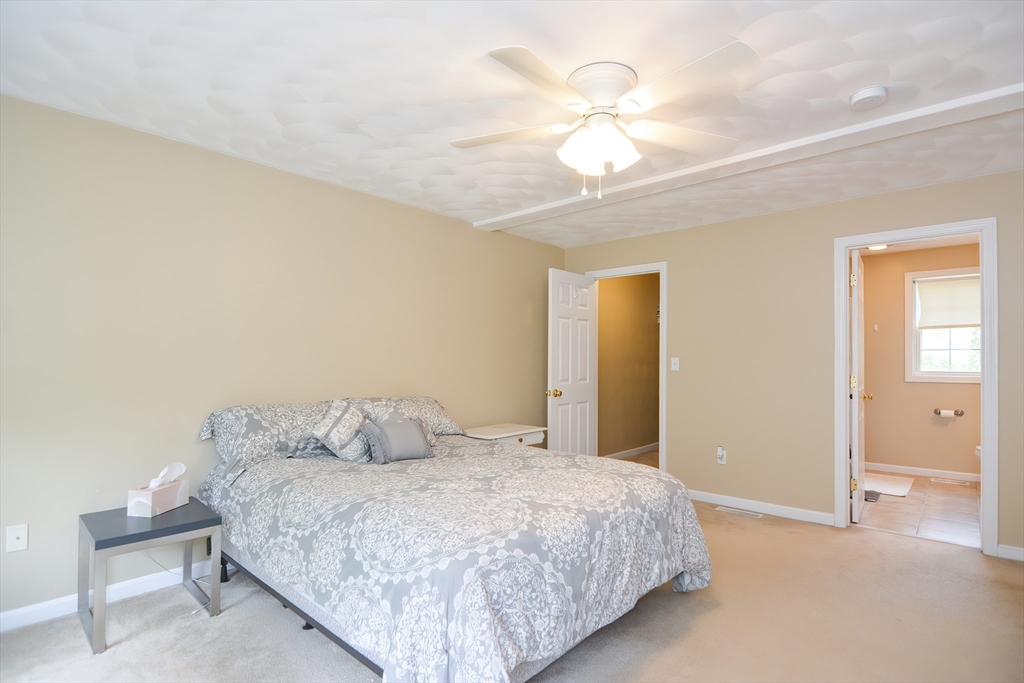 146 Gray Road Templeton, MA 01468 - Photo 19 of 37 a bedroom with a bed and a chandelier