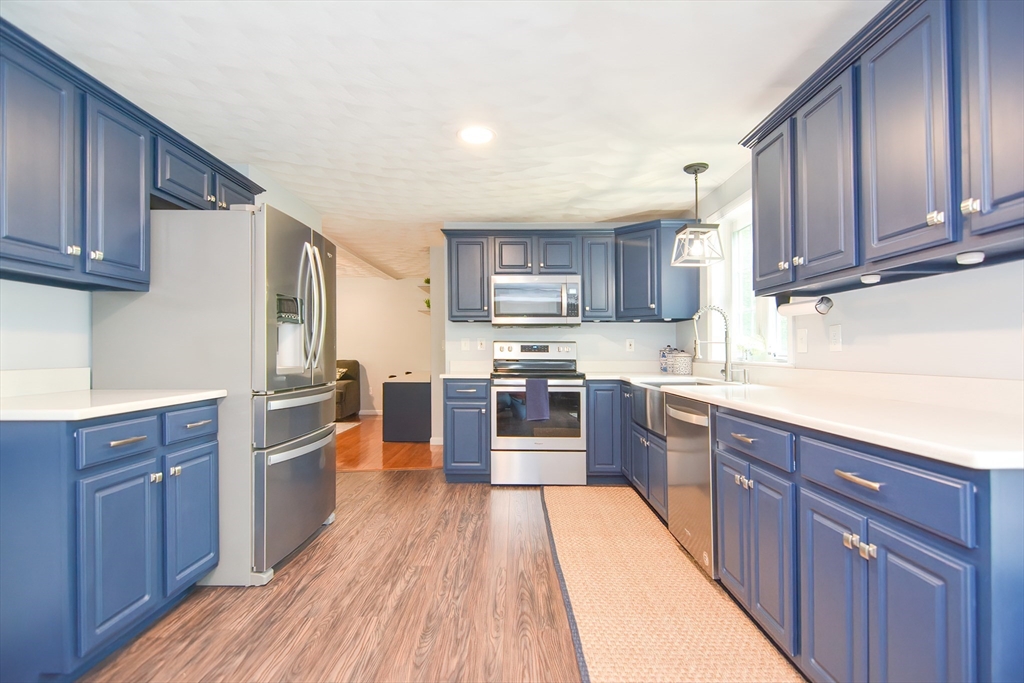 146 Gray Road Templeton, MA 01468 - Photo 7 of 37 a large kitchen with wooden floors stainless steel appliances and a sink