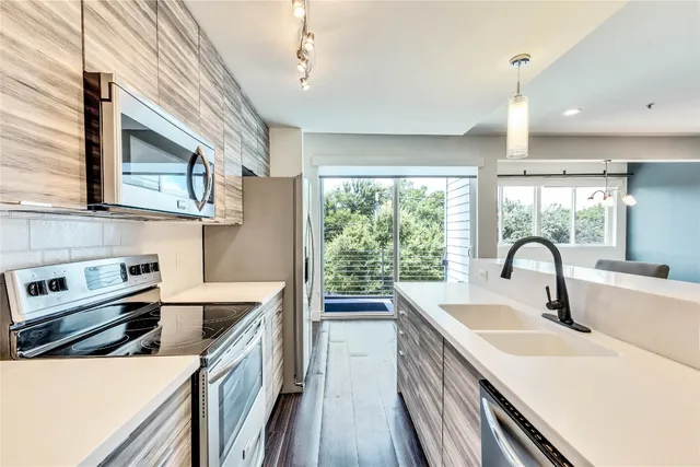 a kitchen with a sink a stove and cabinets