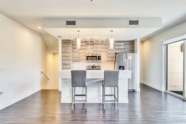 a view of a dining room with furniture and wooden floor