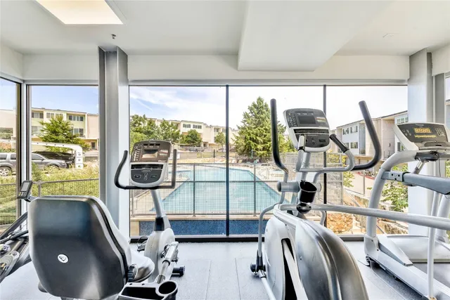 a view of swimming pool with outdoor seating and house in the background