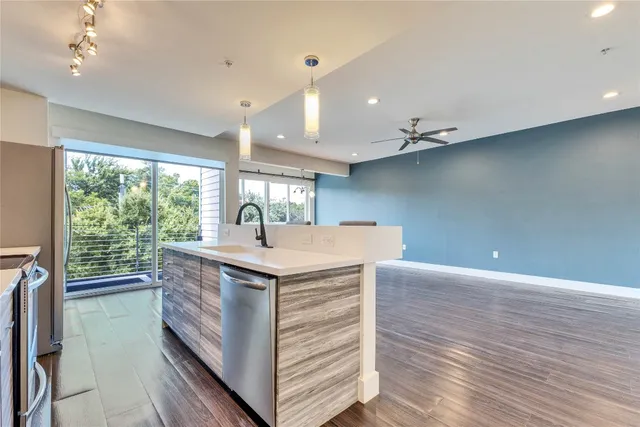 a kitchen with kitchen island a sink and wooden floor