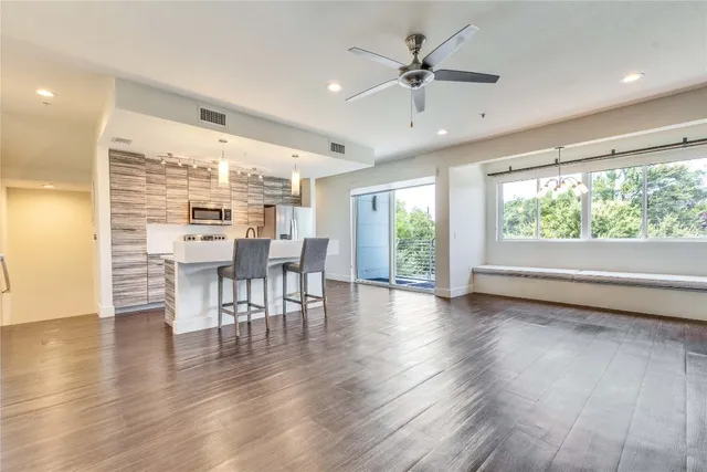a view of a livingroom with furniture window and wooden floor
